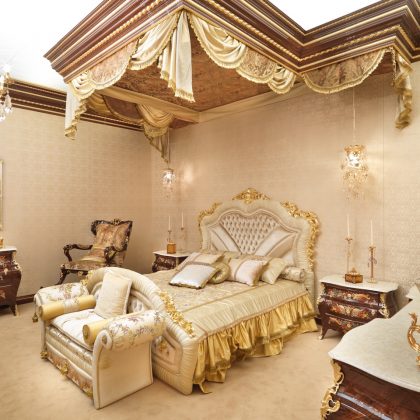 A luxurious bedroom of royal design with a magnificent four-poster bed and exquisite golden details.