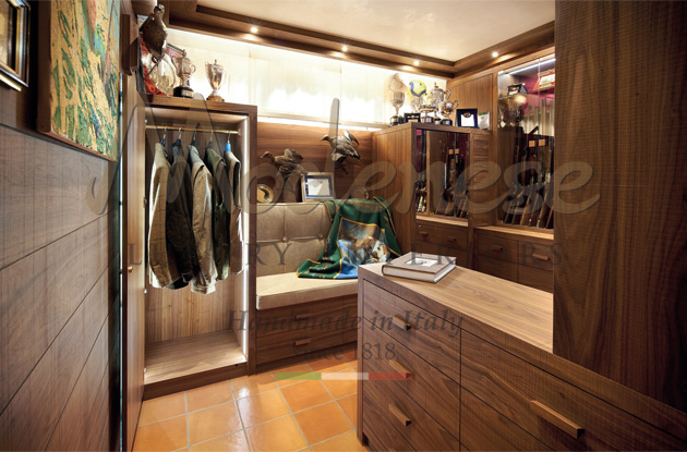 Walnut dressing room with hanging clothes designed by Modenese Luxury Interiors