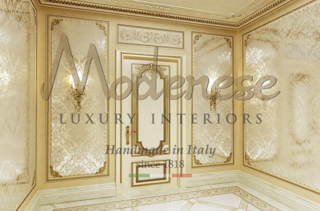 Modenese luxury doors with gold details and decorations and elegant wallpaper