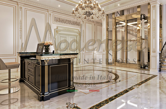 Hospitality interior design by Modenese Interiors dark walnut desk with gold leaf details and light marble floors