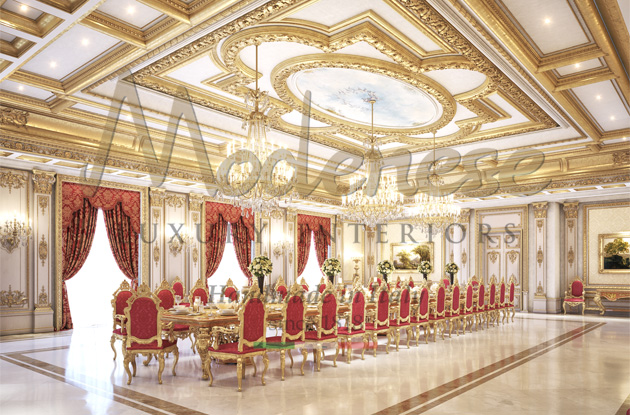 Modenese majestic table and red upholstered chairs under a richly decorated ceiling