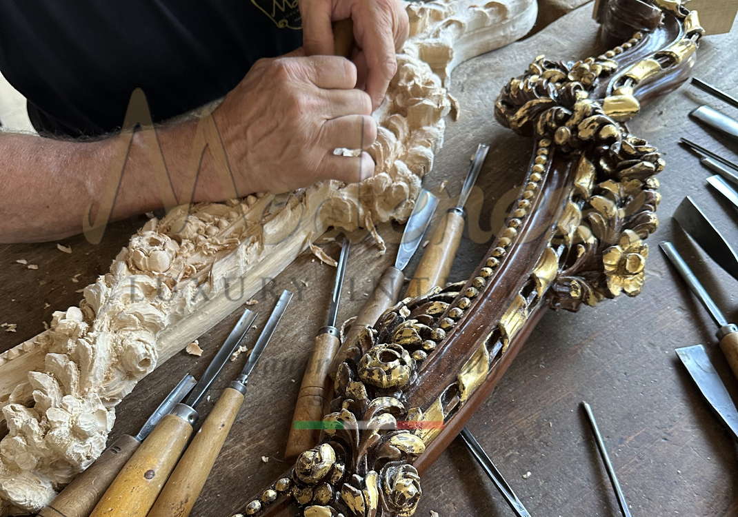 Artisan hand carving details on wood with tools Modenese walnut and gold leaf product