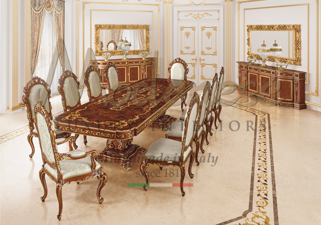 Classic walnut dining room with inlaid rectangular table and 10 white fabric upholstered chairs walnut sideboards and gold leaf hand carved mirror Modenese