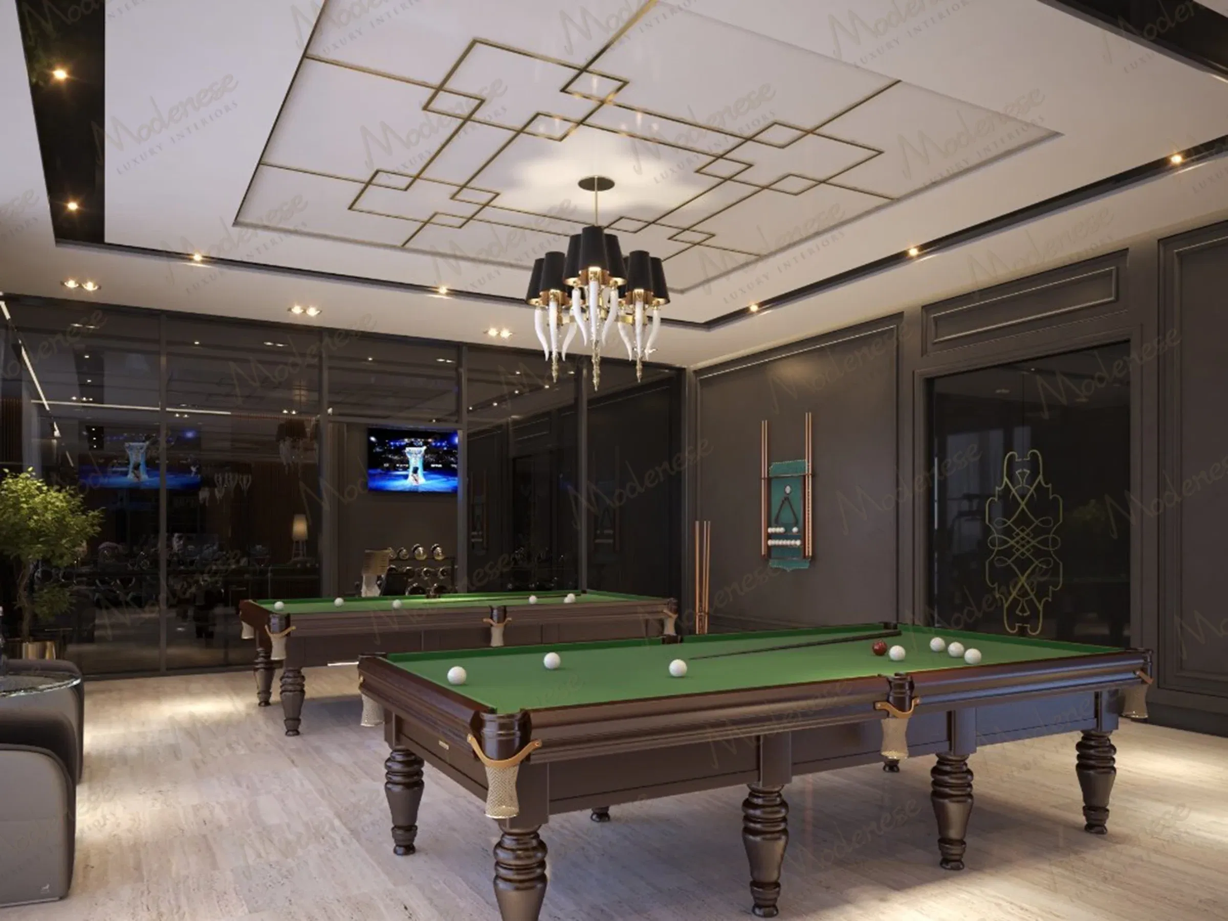 غرفة بلياردو فاخرة في فيلا أربيل تتميز بجدران مكسوة بالخشب الداكن وطاولتي بلياردو باللون الأخضر وإضاءة سقف هندسية حديثة
