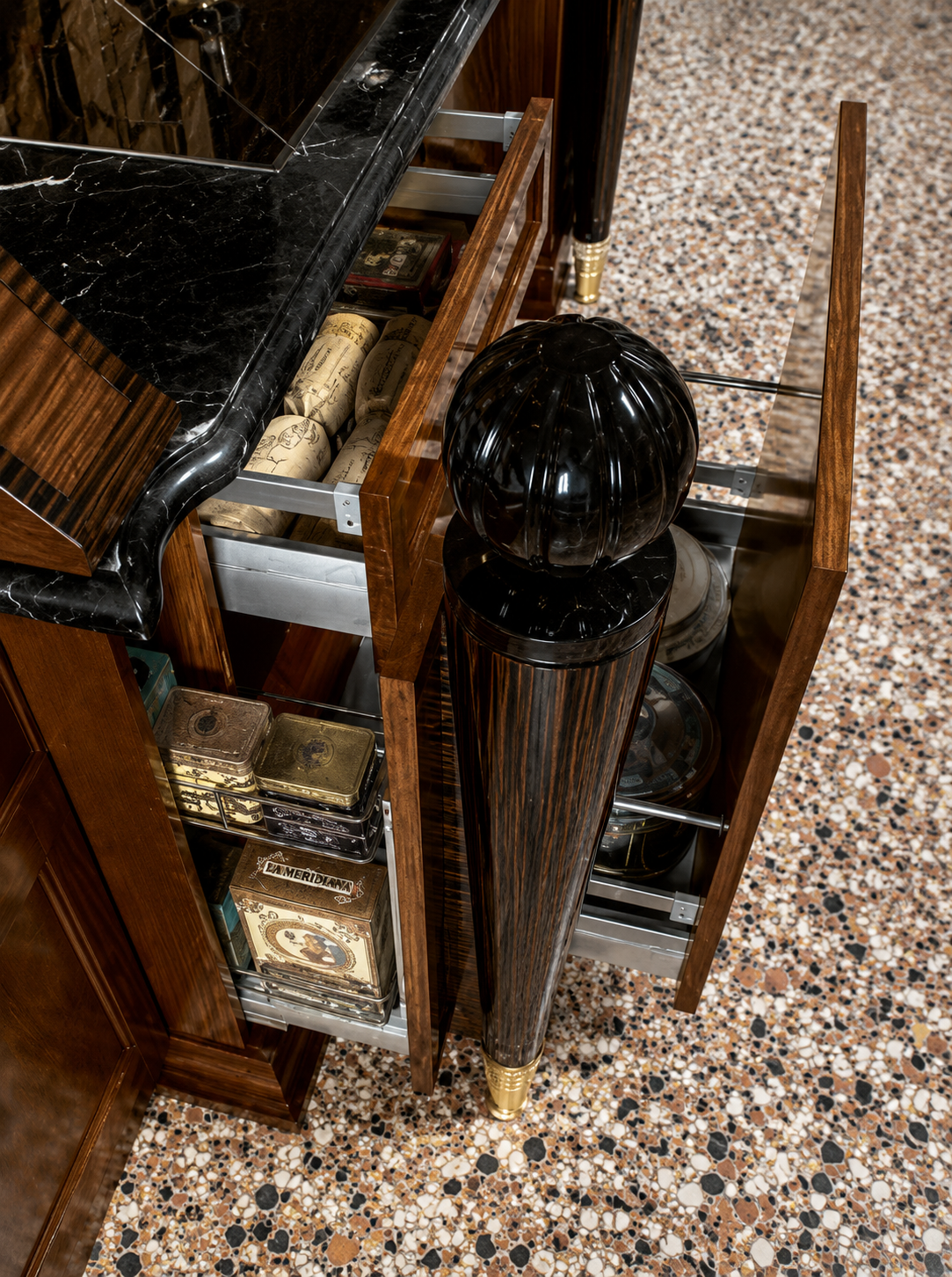 Bespoke pull-out storage beside a black marble worktop in the Majestic kitchen, Jeddah