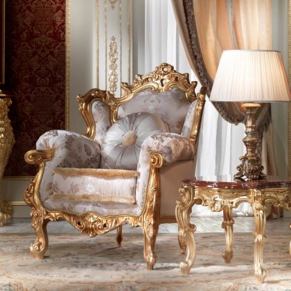 Luxury armchair with detailed upholstery and intricate wood carvings for a timeless and elegant addition to any interior.